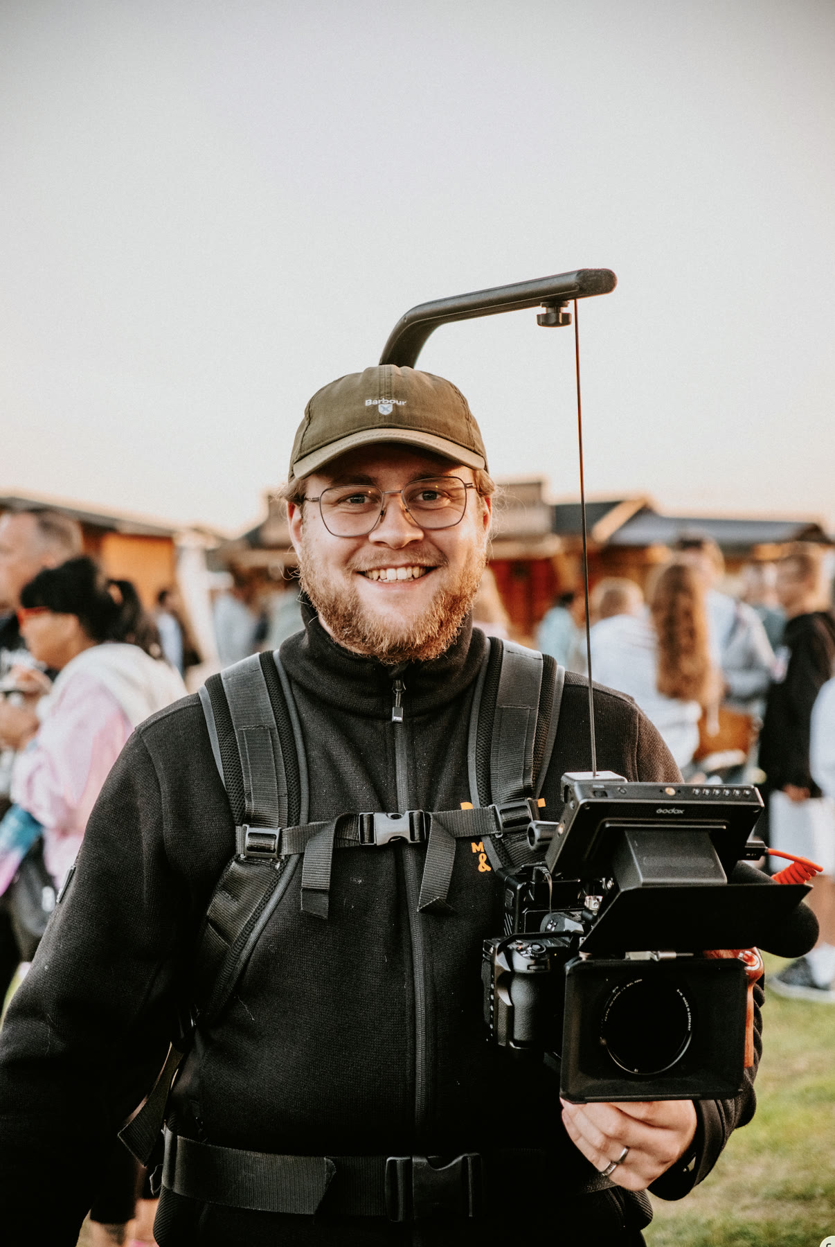 Jasper von Harlem – Hochzeitsfotograf & Hochzeitsvideograf Jasper von Harlem, Hochzeitsfotograf und Hochzeitsvideograf, lächelnd mit Kamera-Equipment